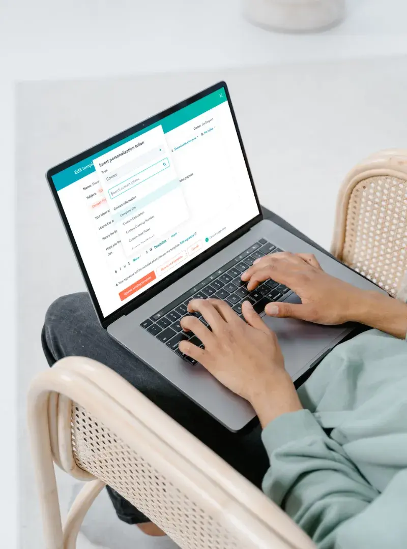 Person typing on a laptop, working with a HubSpot CRM dashboard interface. Person typing on a laptop, working with a HubSpot CRM dashboard interface.